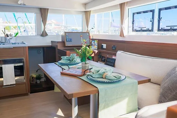 Southern Wild Yacht Photos Pics Interior of 2018 Lagoon 40 catamaran with elegant dining setup and modern design.