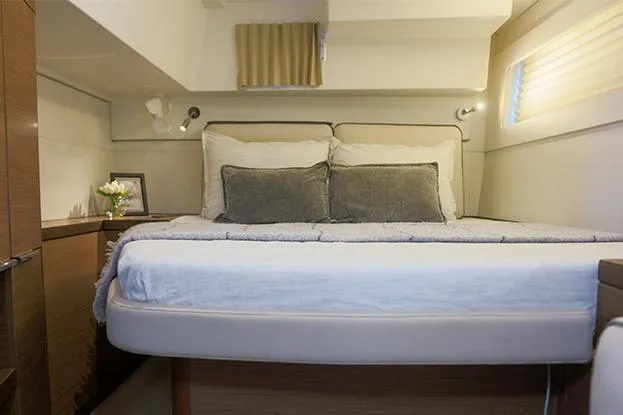 Southern Wild Yacht Photos Pics Luxurious cabin interior of 2018 Lagoon 40 catamaran with cozy bed and elegant decor.
