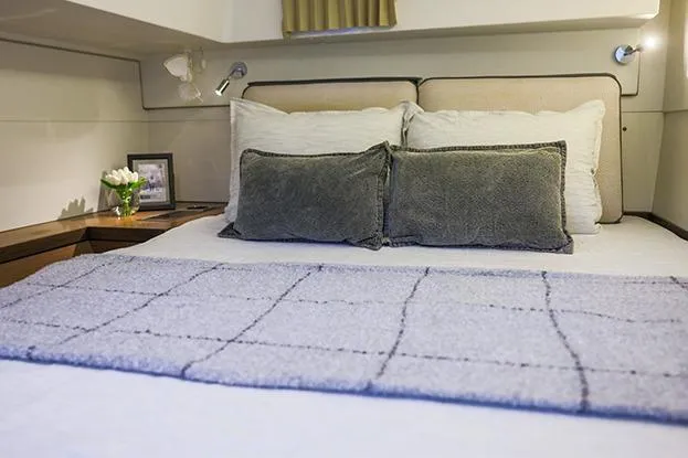 Southern Wild Yacht Photos Pics Luxurious bedroom interior of 2018 Lagoon 40 yacht with cozy bedding and elegant decor.