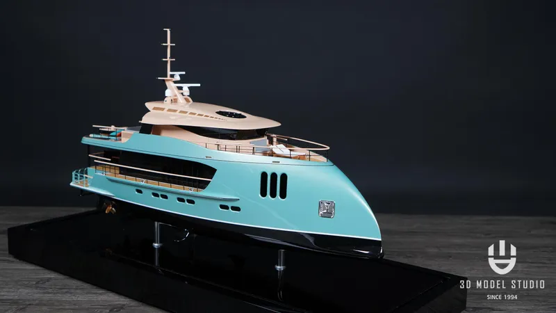 Deo Juvante Yachts Yacht Photos Pics Model of 2026 Deo Juvante M24 yacht with sleek turquoise design on display stand.