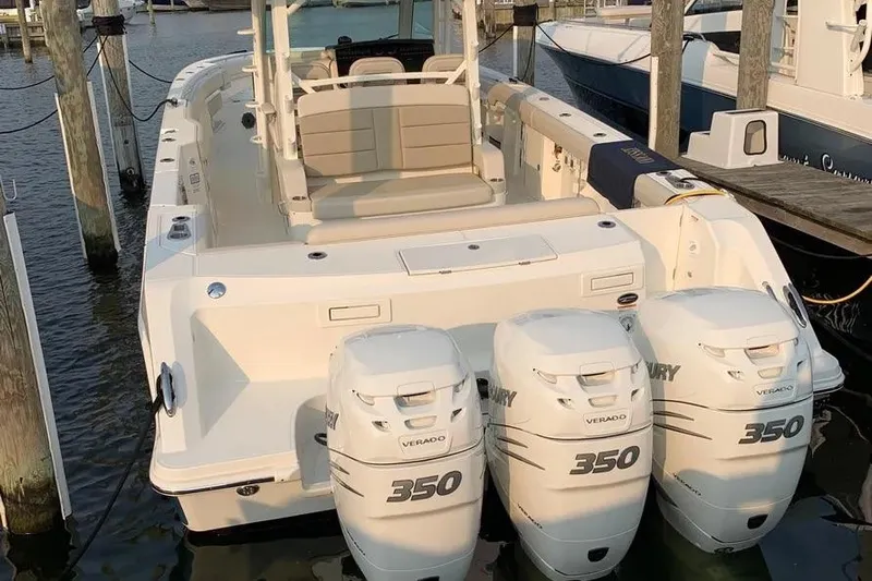  Yacht Photos Pics 2019 Boston Whaler 380 Outrage with triple Mercury 350 engines docked at marina.