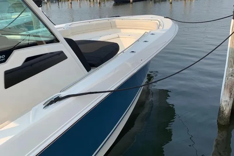  Yacht Photos Pics 2019 Boston Whaler 380 Outrage boat docked in calm waters.