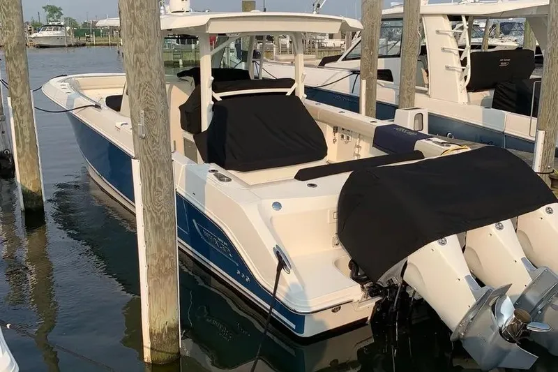  Yacht Photos Pics 2019 Boston Whaler 380 Outrage docked, featuring dual outboard engines and sleek design.