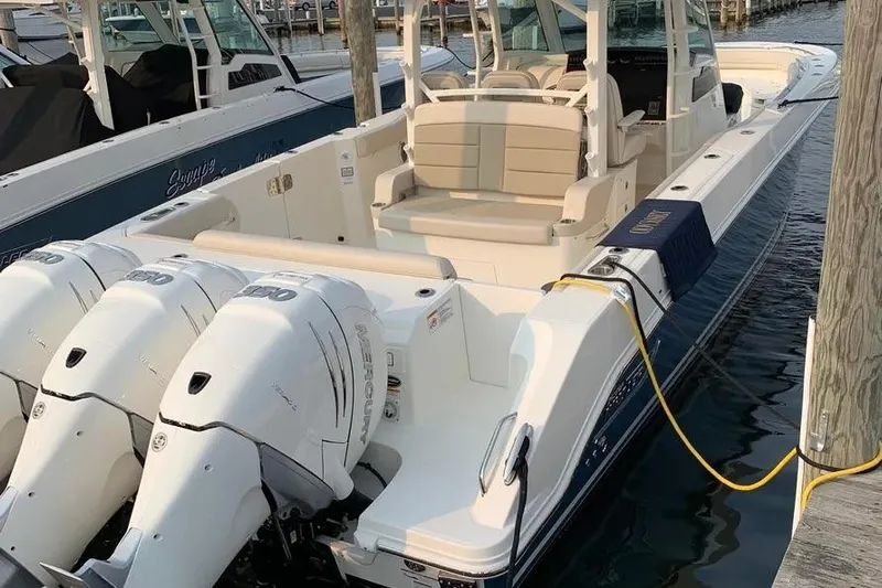  Yacht Photos Pics 2019 Boston Whaler 380 Outrage boat docked with triple Mercury engines.