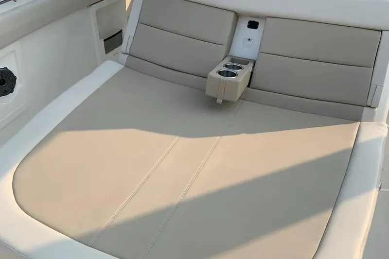  Yacht Photos Pics 2019 Boston Whaler 380 Outrage boat interior with beige seating and cup holders.