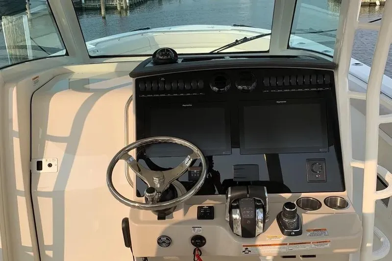  Yacht Photos Pics 2019 Boston Whaler 380 Outrage helm with dual screens and steering wheel.