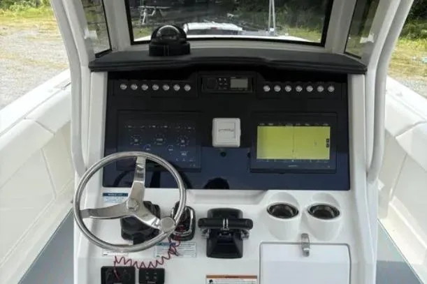  Yacht Photos Pics 2020 World Cat 280 CC-X boat dashboard with steering wheel and navigation controls.