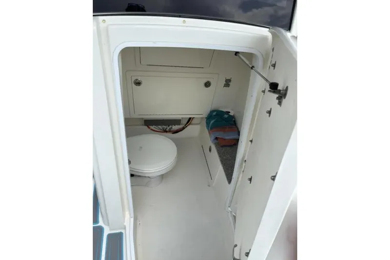 Yacht Photos Pics 2020 World Cat 280 CC-X boat interior with toilet and storage compartment.