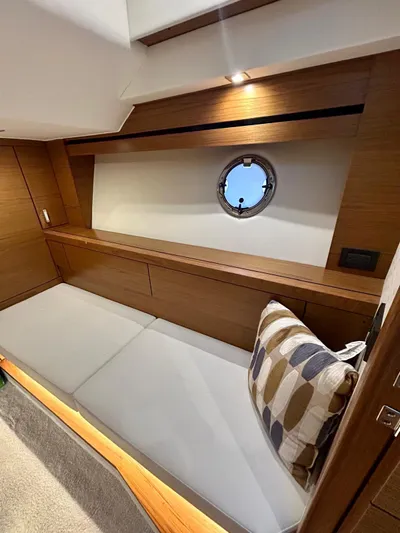  Yacht Photos Pics 2022 Tiara Yachts C39 Coupe interior with wooden finish and porthole window.