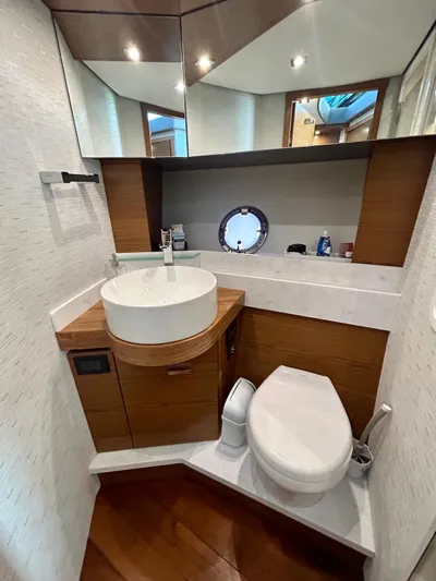  Yacht Photos Pics 2022 Tiara Yachts C39 Coupe bathroom with modern fixtures and wood accents.