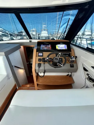  Yacht Photos Pics 2022 Tiara Yachts C39 Coupe helm with modern navigation controls and panoramic marina view.