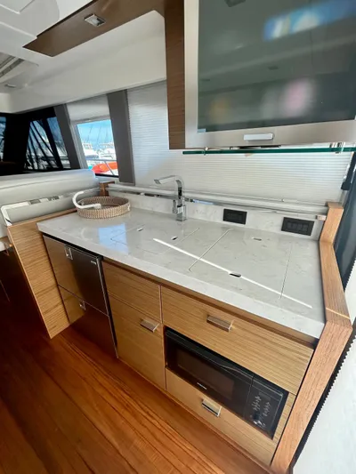  Yacht Photos Pics 2022 Tiara Yachts C39 Coupe interior kitchen with modern appliances and sleek design.