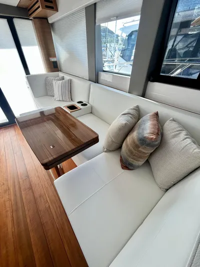  Yacht Photos Pics Interior of 2022 Tiara Yachts C39 Coupe with elegant seating and wooden table.