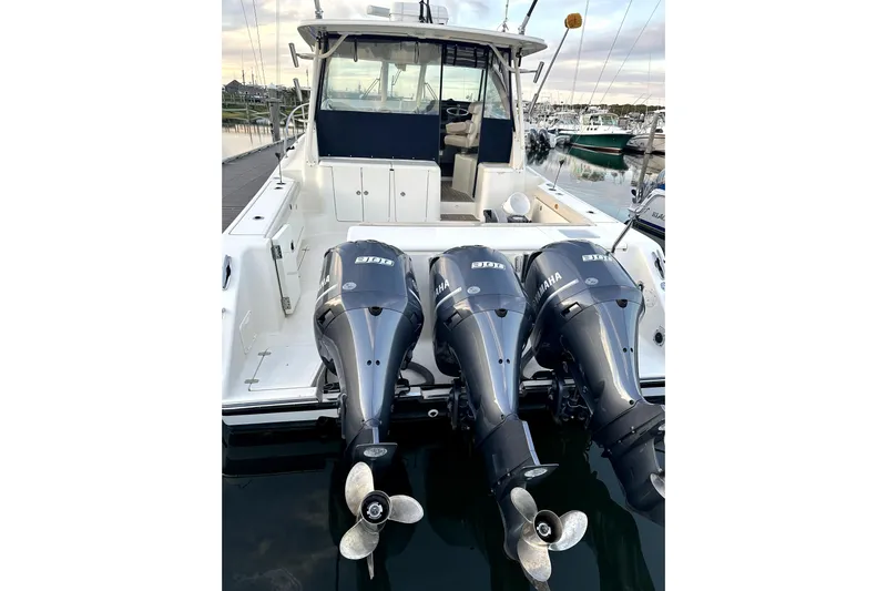 Change Of Pace Yacht Photos Pics 2014 PURSUITE 385 boat with triple Yamaha outboard engines docked at marina.