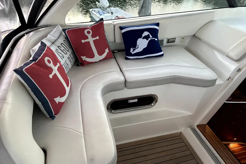 Change Of Pace Yacht Photos Pics Luxurious 2014 PURSUITE 385 yacht interior with nautical-themed cushions and elegant seating.