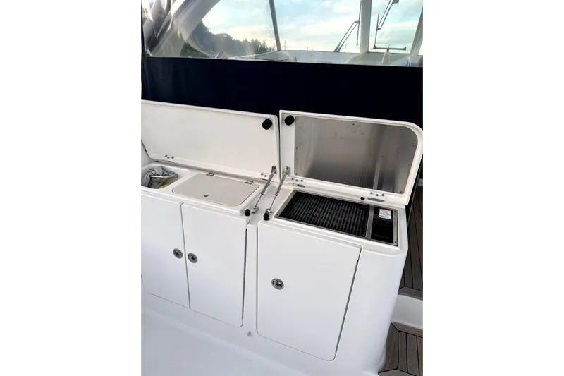 Change Of Pace Yacht Photos Pics Outdoor kitchen area on a 2014 PURSUITE 385 boat, featuring storage and grill.