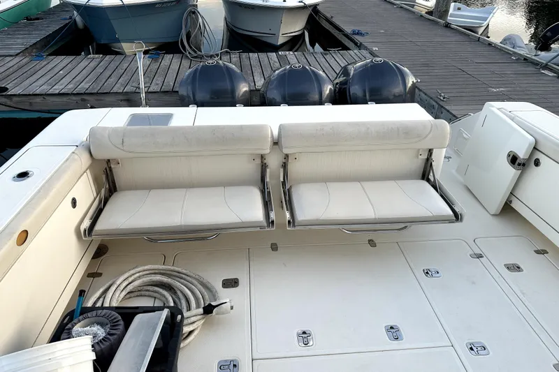Change Of Pace Yacht Photos Pics 2014 PURSUITE 385 boat interior with white seating and docked engines.