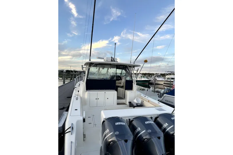 Change Of Pace Yacht Photos Pics 2014 PURSUITE 385 boat docked, featuring Yamaha engines, under a clear sky.