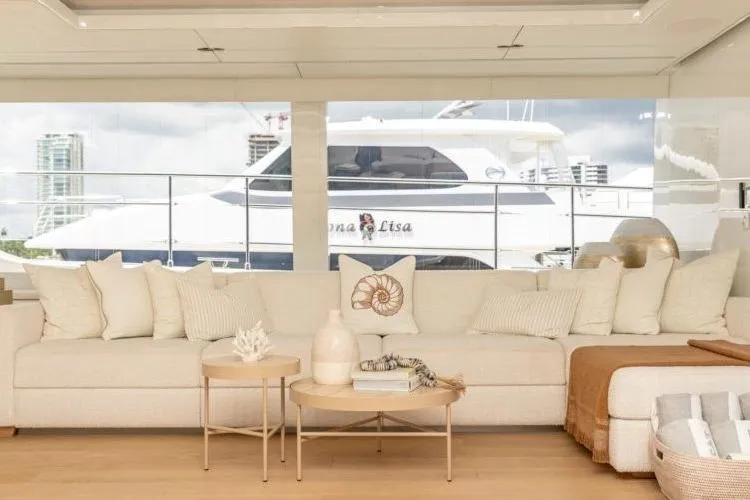 Fat Cat Yacht Photos Pics Luxurious Sunreef Fat Cat 2024 yacht interior with elegant beige seating and decorative pillows.