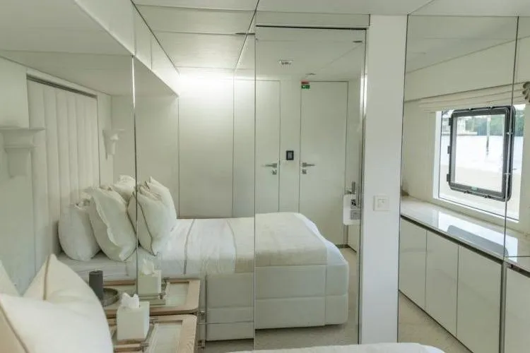 Fat Cat Yacht Photos Pics Luxurious 2024 Sunreef Fat Cat yacht bedroom with modern white interior design.