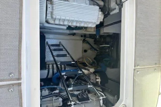  Yacht Photos Pics Engine compartment of a 2006 Sea Ray 52 Sundancer yacht with visible ladder and components.