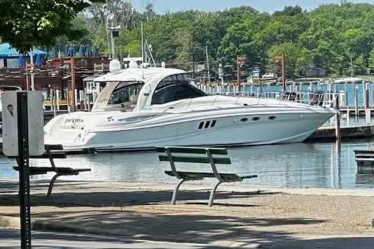  Yacht Photos Pics 2006 Sea Ray 52 Sundancer yacht docked at a marina with lush greenery.