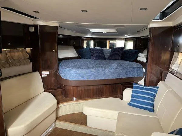  Yacht Photos Pics Luxurious interior of 2017 Sea Ray Sundancer 350 with cozy seating and elegant bedding.
