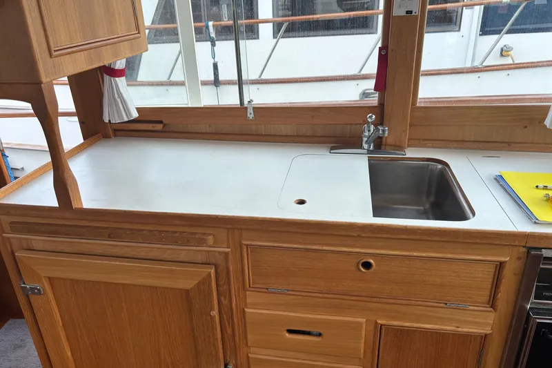  Yacht Photos Pics 1991 Grand Banks 36 Classic yacht kitchen with wooden cabinetry and stainless steel sink.