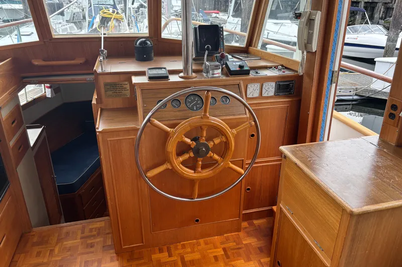  Yacht Photos Pics Helm of 1991 Grand Banks 36 Classic yacht with wooden steering wheel and navigation instruments.
