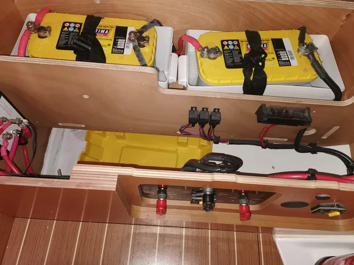 Chilled Yacht Photos Pics Battery compartment of 2013 Jeanneau Sun Odyssey 469 sailboat, featuring yellow marine batteries.