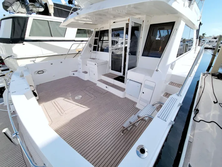 Wavos Rancheros Yacht Photos Pics 1999 West Bay 58 Sonship yacht with spacious deck and modern design.