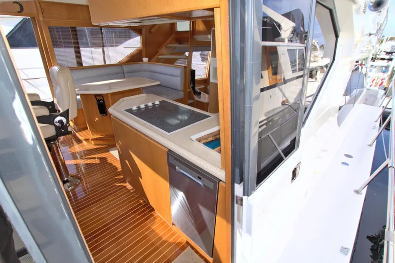 Wavos Rancheros Yacht Photos Pics Interior view of 1999 West Bay 58 Sonship yacht, featuring modern kitchen and seating area.