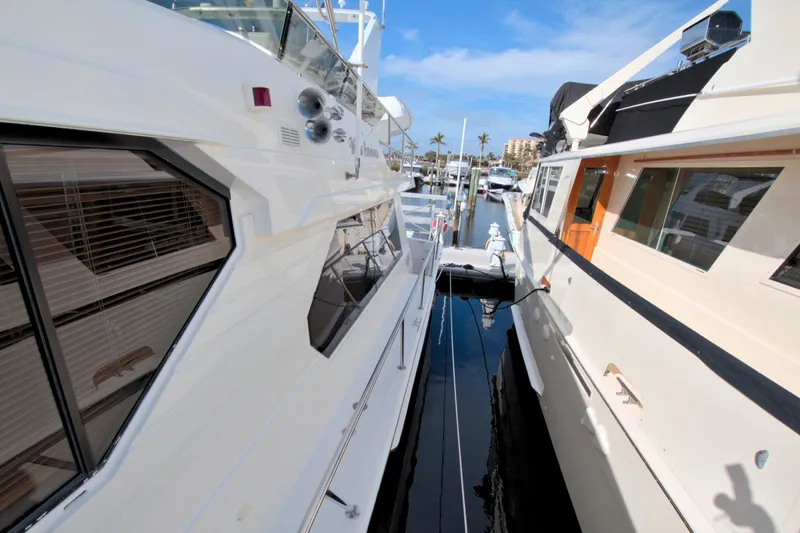 Wavos Rancheros Yacht Photos Pics 1999 West Bay 58 Sonship yacht docked at marina, side view.