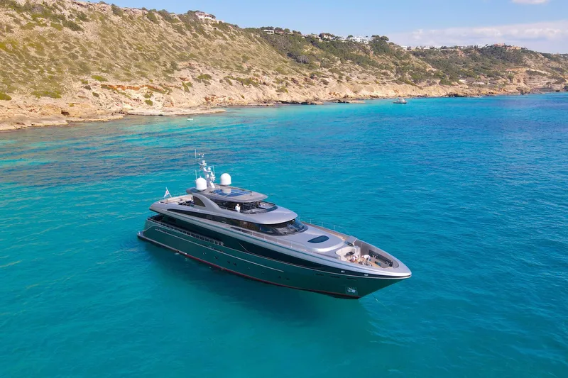 Smooth Operator Yacht Photos Pics Luxurious 2011 Jongert 39m yacht cruising in clear turquoise waters near rocky coastline.