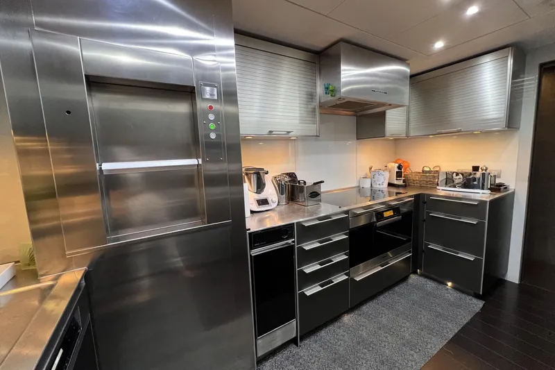 Smooth Operator Yacht Photos Pics Modern yacht kitchen with stainless steel appliances, sleek cabinets, and under-cabinet lighting on a Jongert 39m.