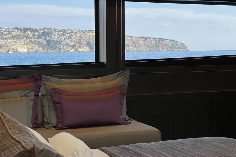 Smooth Operator Yacht Photos Pics Luxurious Jongert 39m yacht interior with ocean view, featuring elegant pillows and scenic coastline, 2011.