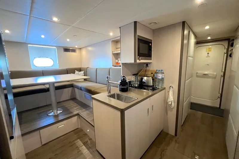 Smooth Operator Yacht Photos Pics Luxurious interior of 2011 Jongert 39m yacht featuring modern kitchenette and cozy dining area.