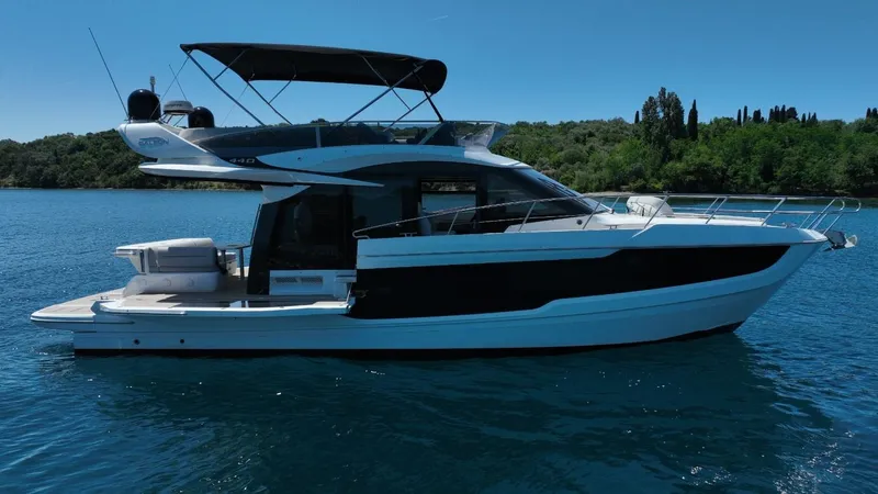  Yacht Photos Pics 2024 Galeon 440 Fly yacht on serene blue water, featuring sleek design and modern amenities.