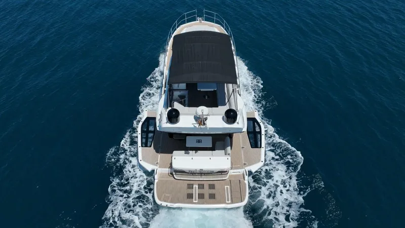  Yacht Photos Pics 2024 Galeon 440 Fly yacht cruising on open water, aerial view.