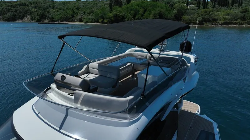  Yacht Photos Pics 2024 Galeon 440 Fly yacht with shaded upper deck on calm water.