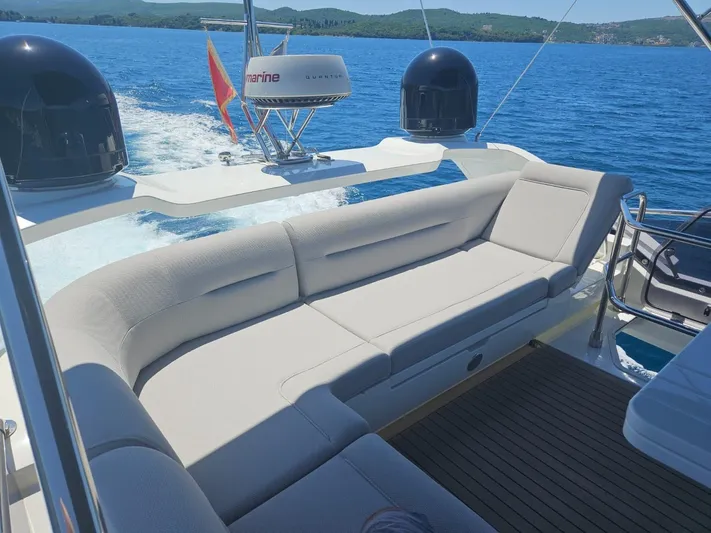  Yacht Photos Pics Luxurious seating on 2024 Galeon 440 Fly yacht, cruising on clear blue waters.