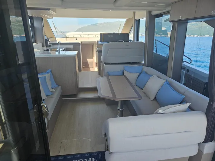  Yacht Photos Pics Luxurious interior of 2024 Galeon 440 Fly yacht with elegant seating and scenic ocean view.