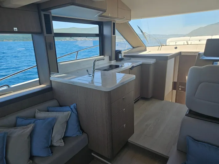  Yacht Photos Pics Luxurious interior of 2024 Galeon 440 Fly yacht with modern kitchen and ocean view.