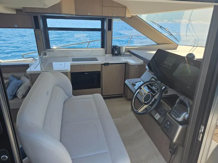  Yacht Photos Pics Interior of 2024 Galeon 440 Fly yacht with modern helm and kitchen area.