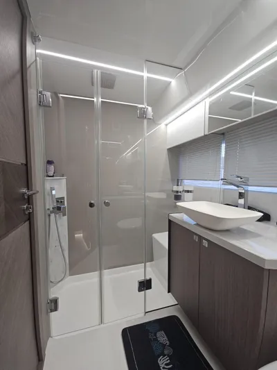  Yacht Photos Pics Modern bathroom in 2024 Galeon 440 Fly yacht with glass shower and sleek fixtures.