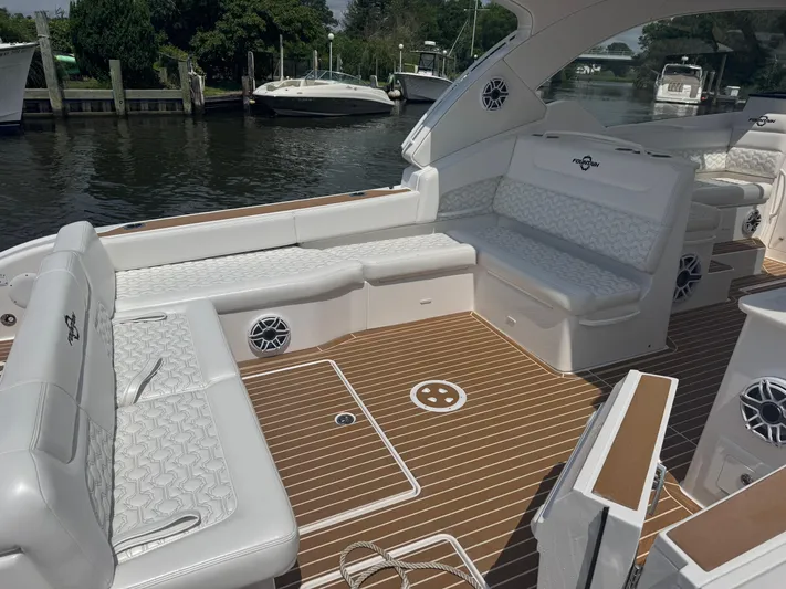  Yacht Photos Pics Luxurious 2025 Fountain 39 DX boat interior with white seating and wood-patterned flooring.