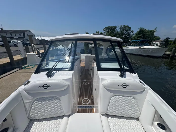  Yacht Photos Pics 2025 Fountain 39 DX boat docked, featuring sleek design and luxurious seating.