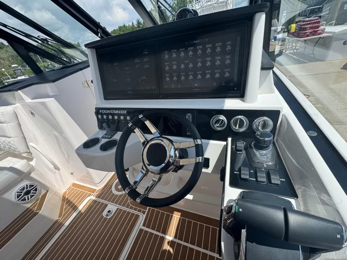  Yacht Photos Pics 2025 Fountain 39 DX boat cockpit with modern steering and control panel.