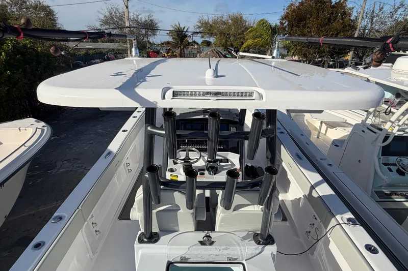  Yacht Photos Pics 2026 Twin Vee 280 GFX2 CC boat with rod holders and T-top in marina.