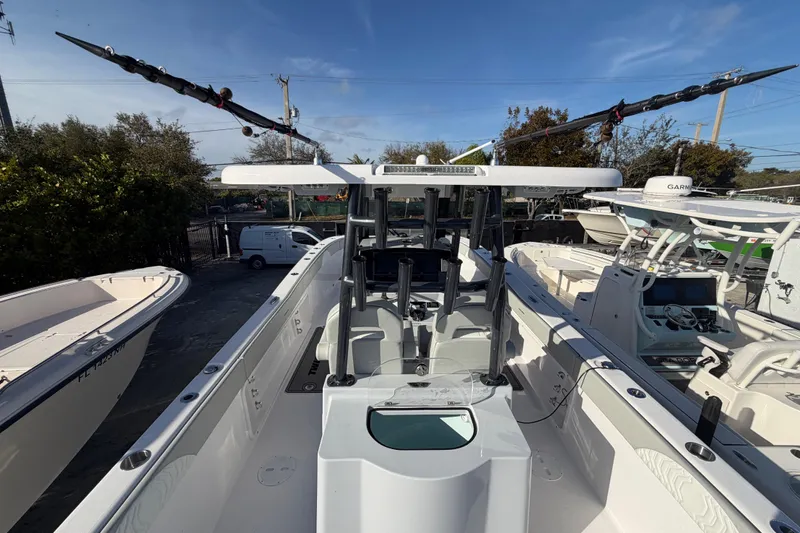  Yacht Photos Pics 2026 Twin Vee 280 GFX2 CC boat, center console, docked with fishing rods.